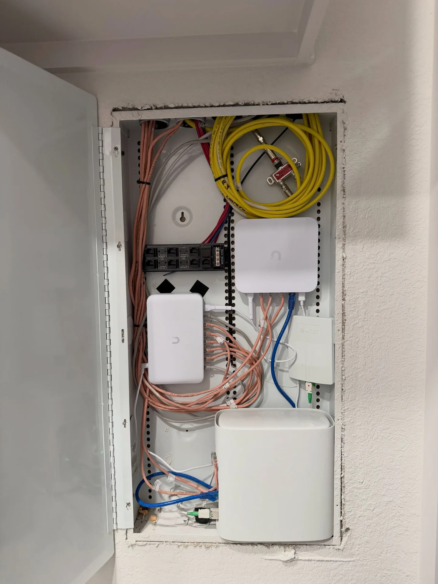 Houston home's network cabinet after equipment replacement and cable organization