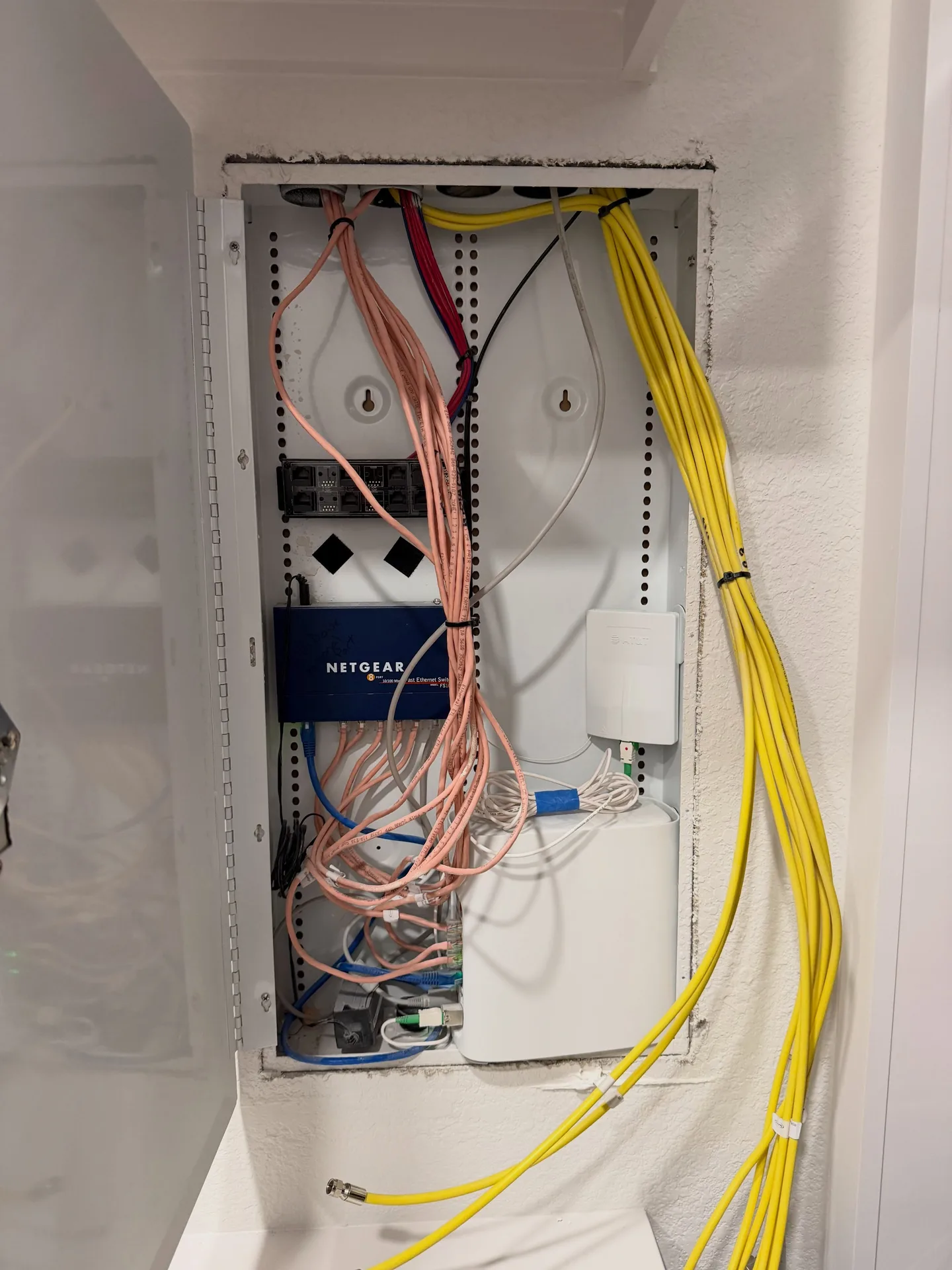 Houston home's network cabinet before the network and AV repair