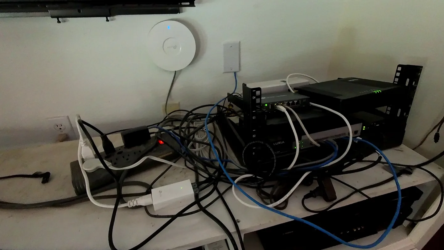 Network rack with loose and overlapping cables before the cleanup